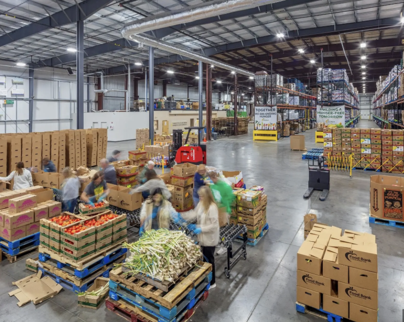 Volunteers sorting donated food in the Harvest Hands warehouse